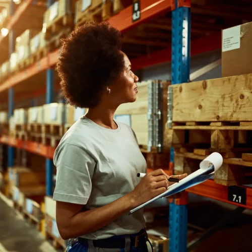 african-american-worker-writing-inventory-list-while-checking-stock-storage-room
